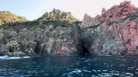 amazing calanques de piana volcanic rock formations in corsica island as seen from moving boat in summer season, france