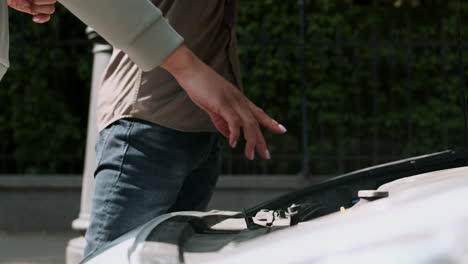 opening car hood during driving lesson