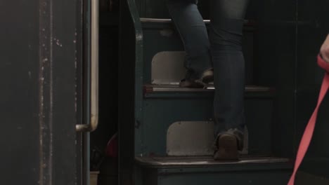 climbing steps of vintage british double decker public transport bus