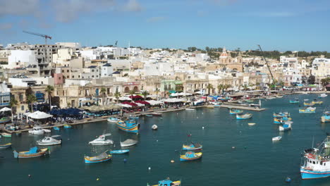 aerial view of marsaxlokk harbour with colorful boats in malta bay