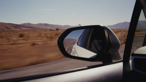 road trip view from car mirror