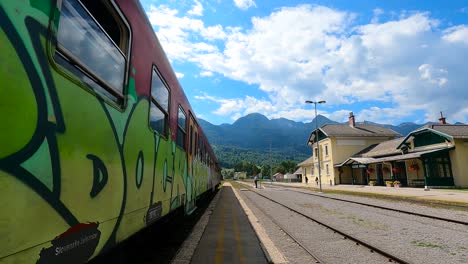 diesel red train leaving bohinjska bistrica station in slovenia