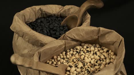 Two-bags-of-dry-beans,-black-turtle-beans-and-black-eyed-peas,-rotate