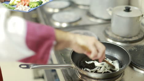 onion frying in a pan. fried onions in a frying pan in oil, for cooking