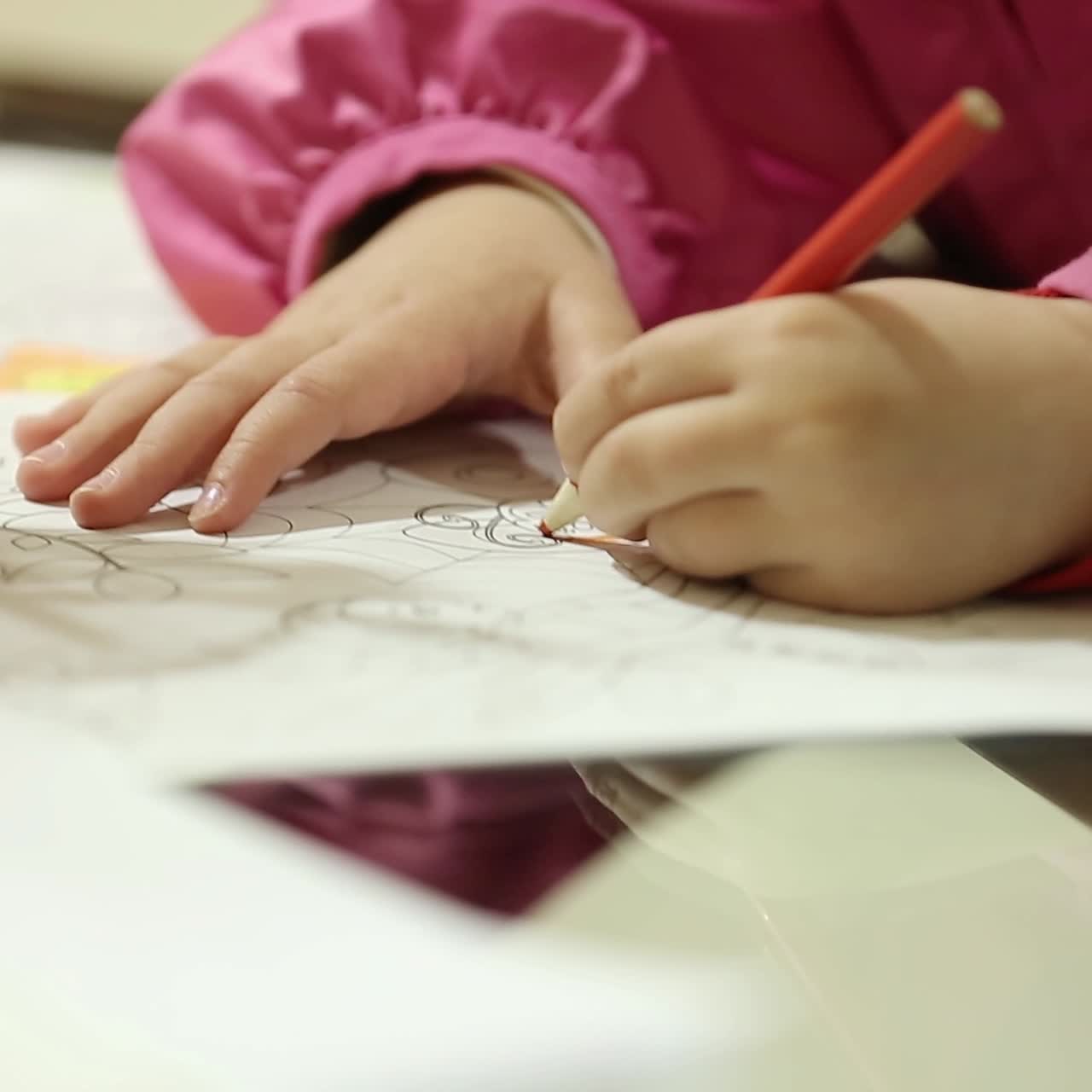 Girl Drawing And Coloring On A Paper