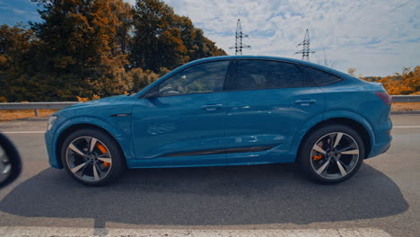 audi e tron profile view. audi e tron, a fully electric car on highway