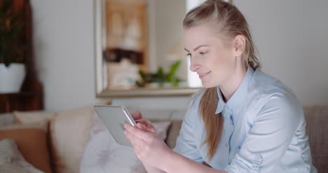 Relaxed-Smiling-Woman-Talking-On-Mobile-Phone-At-Home-3