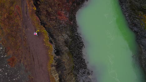 Couple-walking-peacefully-hand-in-hand-through-Studlagil-canyon