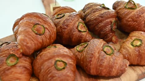 freshly baked arabic croissants with green chillies on the top