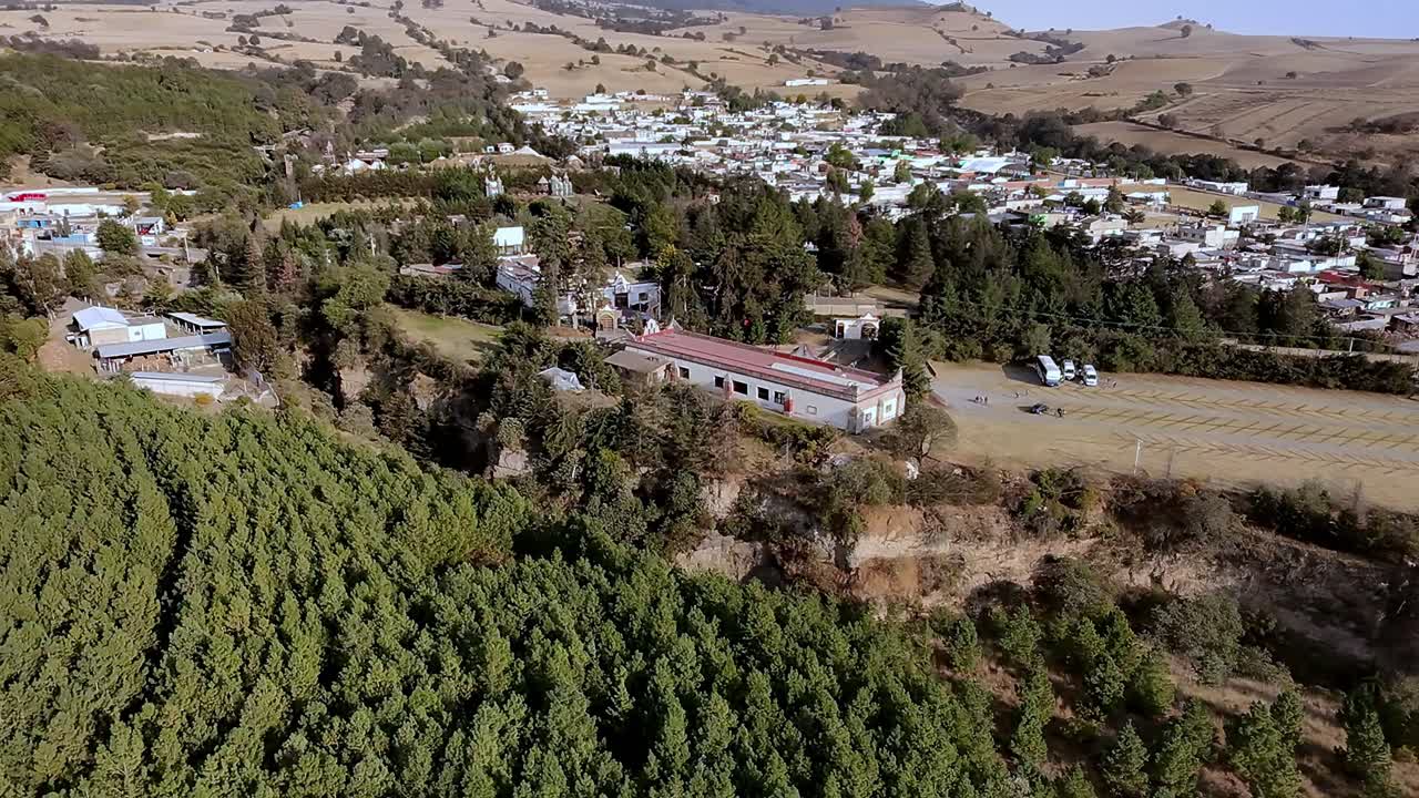 Aerial: Ex Hacienda de San Jacinto Ixtoluca, landscape view with houses and trees during the day in La Mezquitera, Morelos, Mexico, pull out drone shot