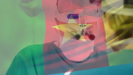 Animation-of-flag-of-cameroon-over-surgeons-in-operating-theatre