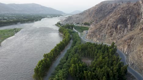 aerial vista of river, hill, road, greenery, and tiny island