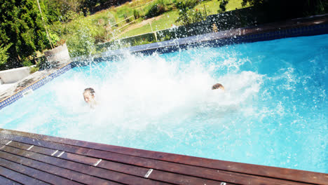 happy friends jumping into swimming pool