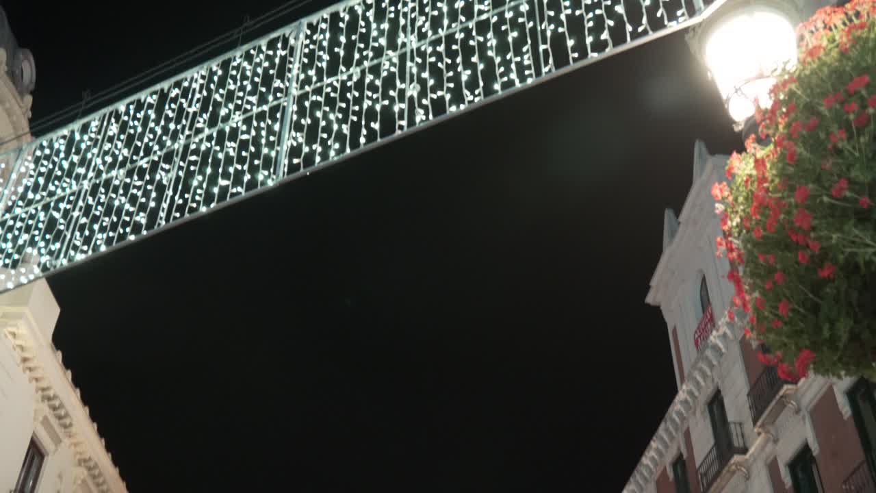 Night view of a city bridge decorated with lights