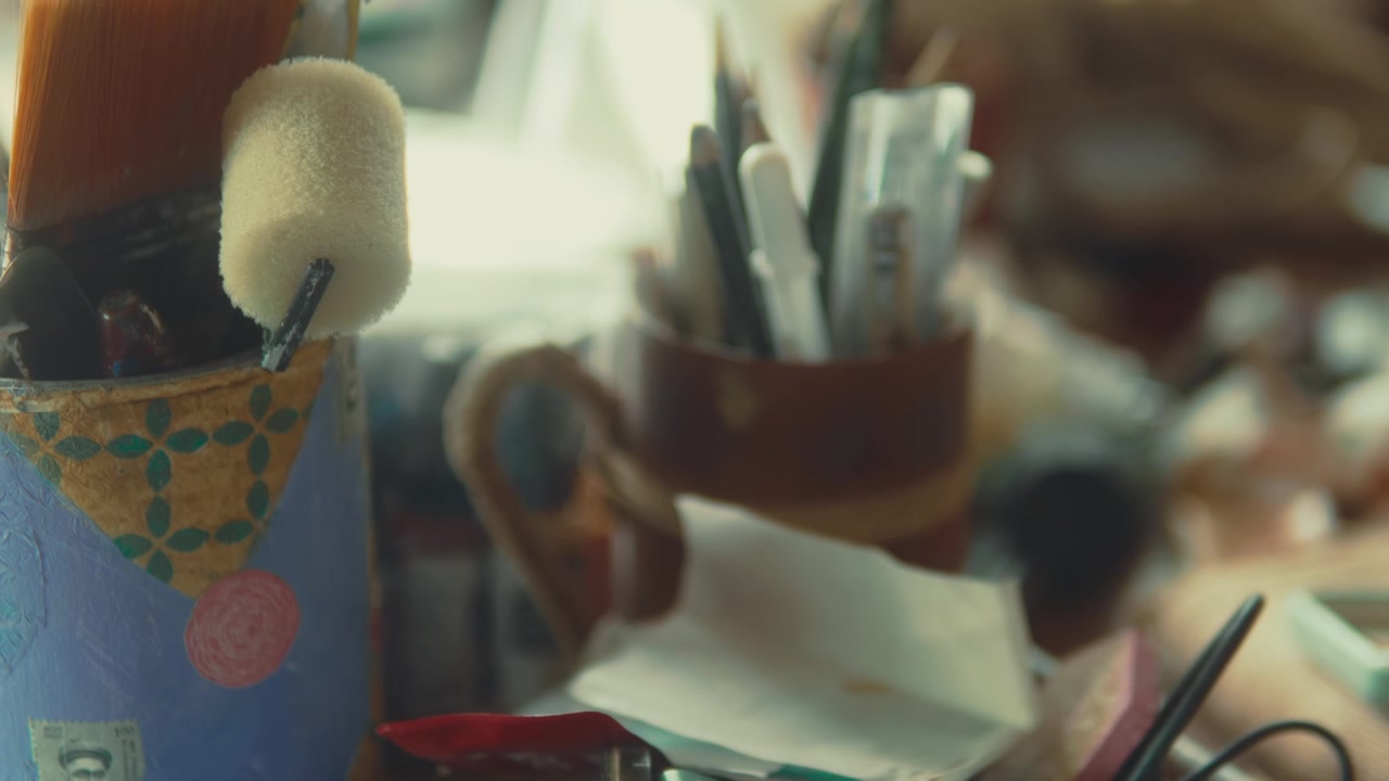 Close up of painting tools in studio with soft focus shifting to sharp