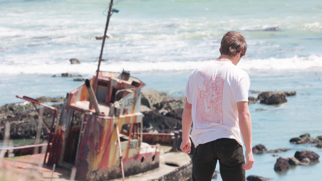 Teenager explores abandoned ship wreck along the California coast.