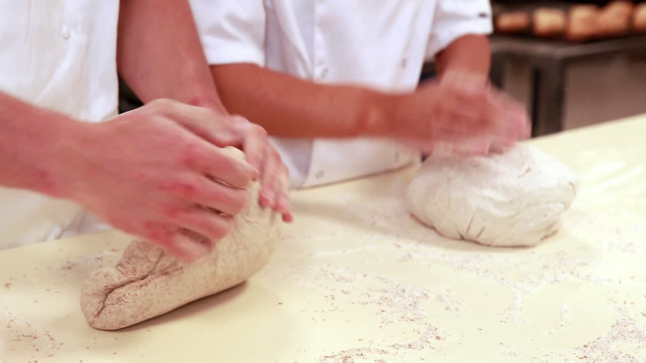 Culinary students kneading dough together