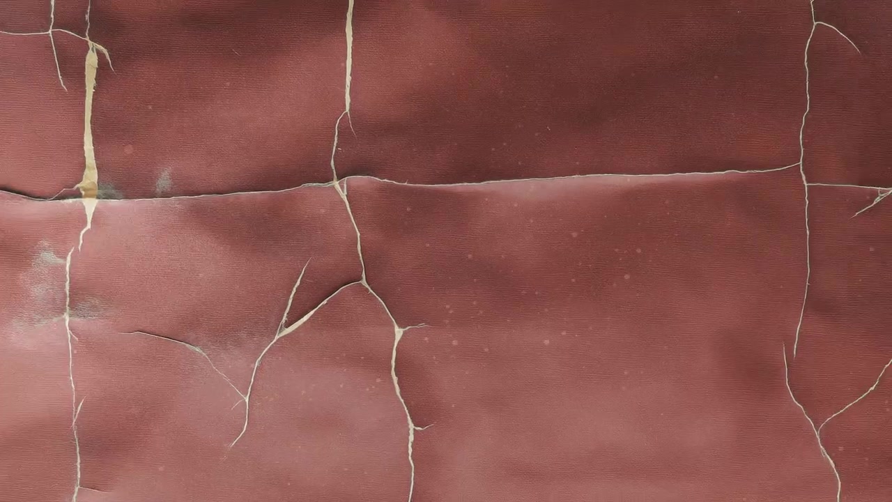 Close-up of Cracked and Peeling Red Surface Texture