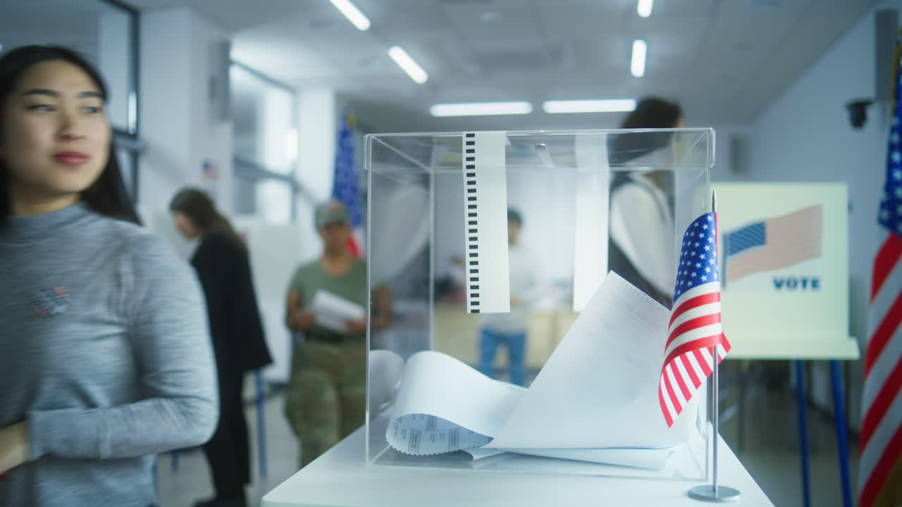 Multiethnic Voters or American People Vote in Booths at Polling Station Multiethnic Voters or American People Vote in Booths at Polling Station Asian Woman and African American Female Military put Bulletins in Box National Election Day in the United States Civic Duty