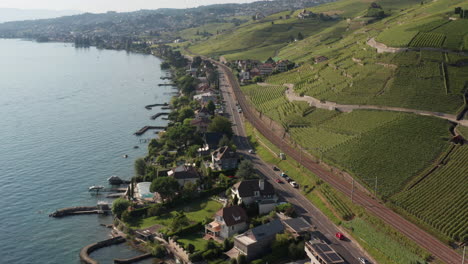 Aerial-of-traffic-driving-over-busy-road-in-small-Swiss-town