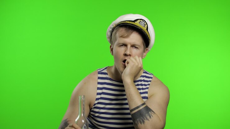 Young sailor man drinks vodka. Seaman guy in sailor's vest. Chroma key