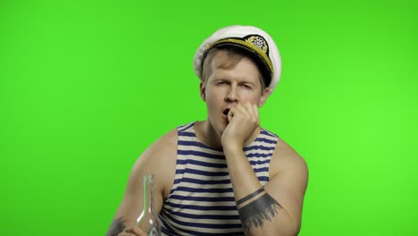 young sailor man drinks vodka. seaman guy in sailor's vest. chroma key