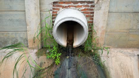 industrial sewage water draining out from cement tube.