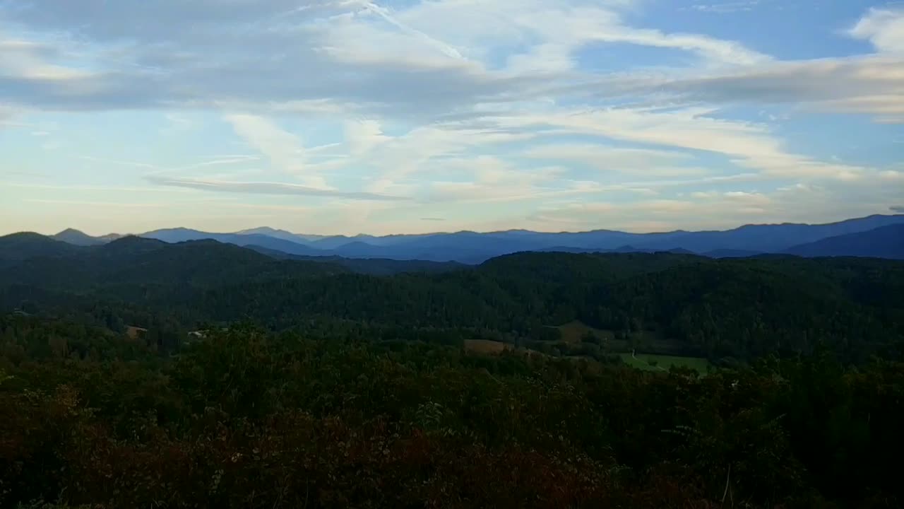 una vista de lapso de tiempo de la luz del día a la oscuridad del parque nacional de las grandes montañas humeantes filmada en la avenida de las colinas ubicada en las montañas humeantes