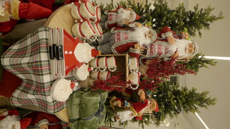 vertical view of christmas decorations at shopping mall, cups, plates and santa