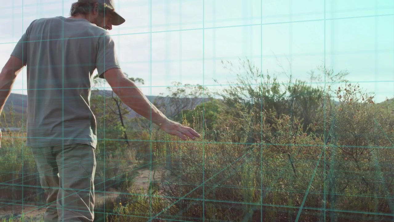 Homem caminhando em um caminho e roçando em plantas, com sobreposição de grade azul-petróleo rastreando o movimento para navegação.