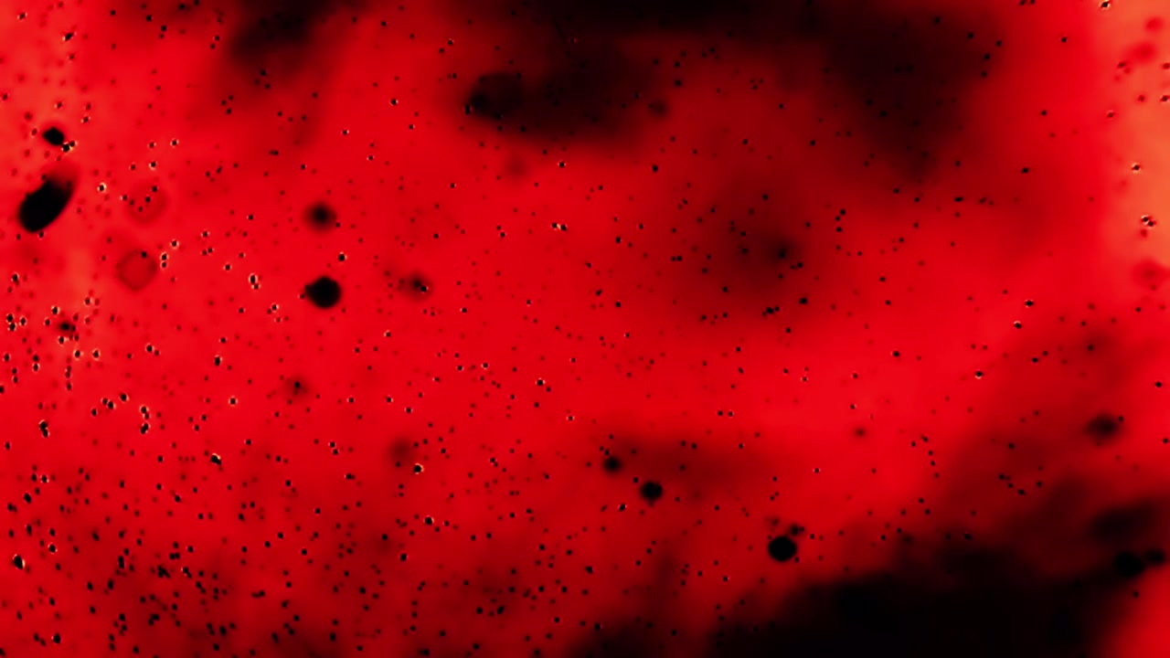 Diffusione astratta di inchiostro rosso e nero in liquido