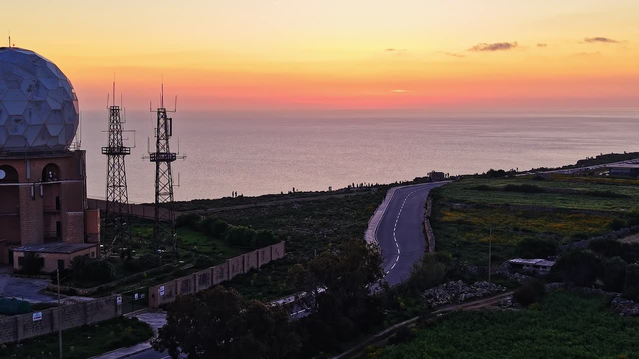 Sunset view from Malta with telecommunications structures and sea