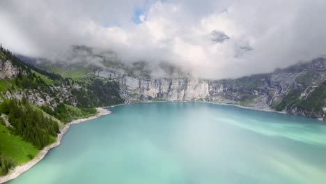 Drone-flight-towards-mountain-Landscape,-aerial-shot-over-a-blue-Oeschinen-lake,-Switzerland,-Europe