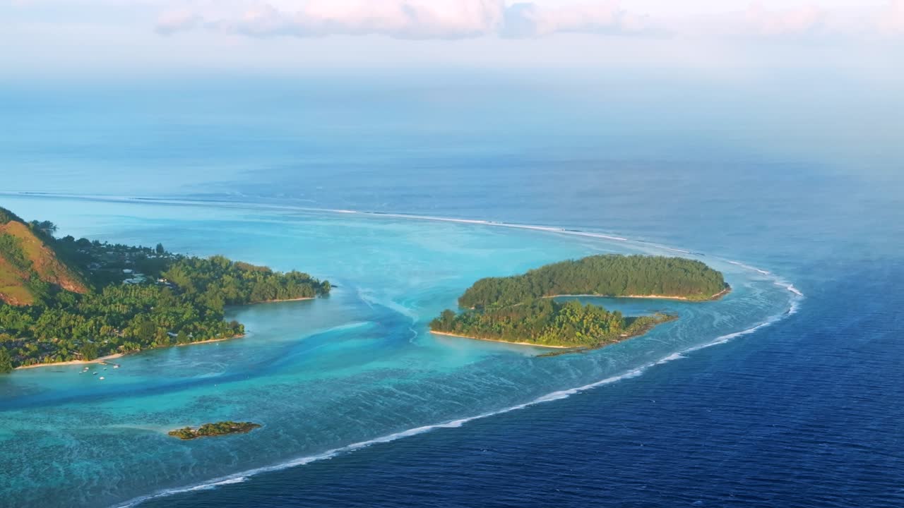 Morning islands Cooks Opunohu Bay Moorea French Polynesia aerial drone Mount Mauaroa Tohivea Rotui clouds lagoon coral reef waves vibrant green blue Pacific Ocean circle right parallax