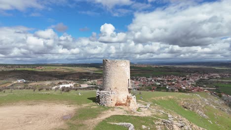 Watch-tower-in-Burgo-de-Osma-medieval-village-in-Soria,-Spain,-aerial-spinning-view-with-the-city-at-the-back