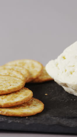 crispy biscuits, cheese and bowl of green olives on tray