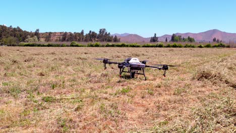 agricultural drone taking off and flying above agro fields and clear sky mountains near andean cordillera, smart farming field industry