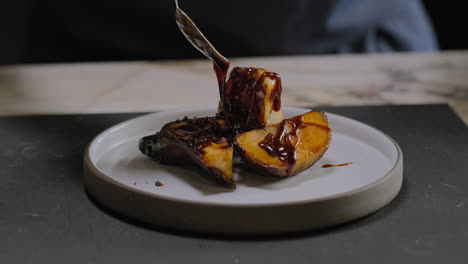 slow motion shot of a chef plating a gourmet sweet potato dish in a restaurant