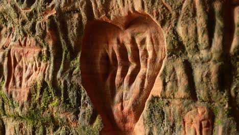 Detail-of-old-inscriptions-engraved-on-cave-wall,-Gutmans-cave,-Latvia