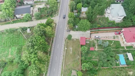 Drone-view-of-vehicle-driving-through-countryside