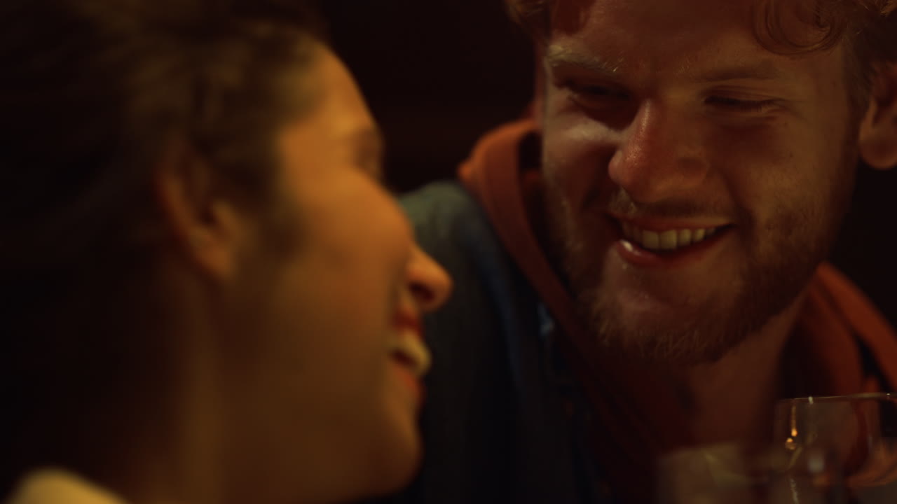 Happy couple drink wine on romantic date. Closeup flirting lovers laugh together