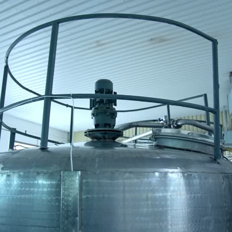 top of the huge cistern for pasteurizing milk. huge cisterns standing in a row at the modern production factory. close up