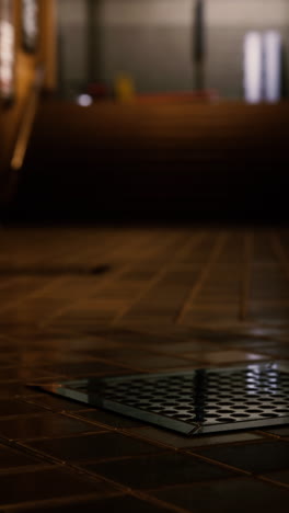 close-up of a metal floor drain in a dark interior