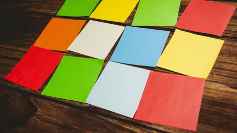 Animation-of-multiple-colourful-cards-lying-on-wooden-table