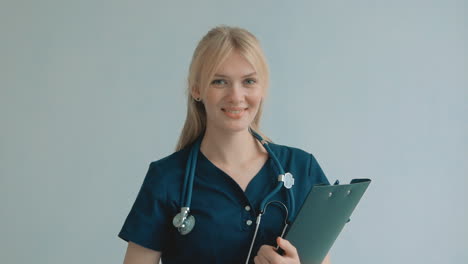 Portrait-Of-Young-Pretty-Blonde-Female-Nurse-Care-Taker-Smiling