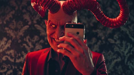 red devil with horns smiling while taking a selfie with a smartphone, dressed in an elegant red suit, positioned in a vintage room adorned with intricate wallpaper