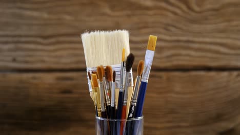 various paintbrush in plastic container