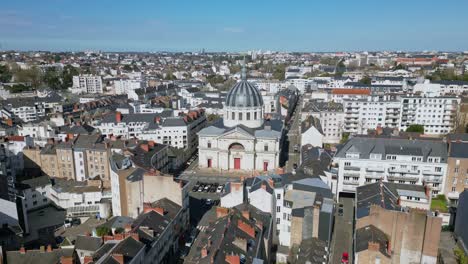 Aerial-circling-view-of-Notre-Dame-de-Bon-Port-church,-Nantes-City-in-France