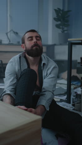 stressed man sitting on office floor