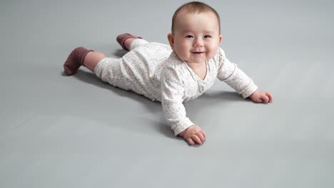 Cute-Baby-Girl-Bed-Lying-On-Her-Belly---close-up,-high-angle